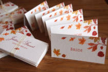 A group of Autumn wedding place name tent cards