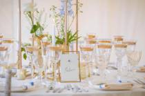 A framed table name in a table setting in amarquee at Osborne House