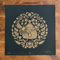 A beehive linocut print in gold ink on 300gsm Somerset Black VelvetPaper