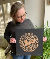 Kathy Pilcher holding her Dandelion Hare linoprint