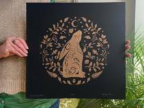 Kathy holding her large moon gazing hare linocut